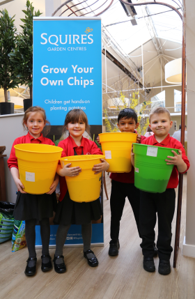 Students from Lea Infant School with their pot of potatoes