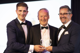 Will Jones receiving his prize from the event compere (left) and Chris Buxton, Chairman of TAF