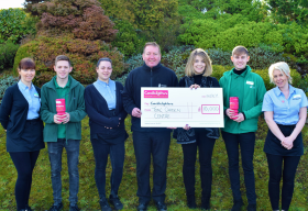 Tong team members with Amy Harrison pictured receiving the cheque from Centre manager Andy Mears 